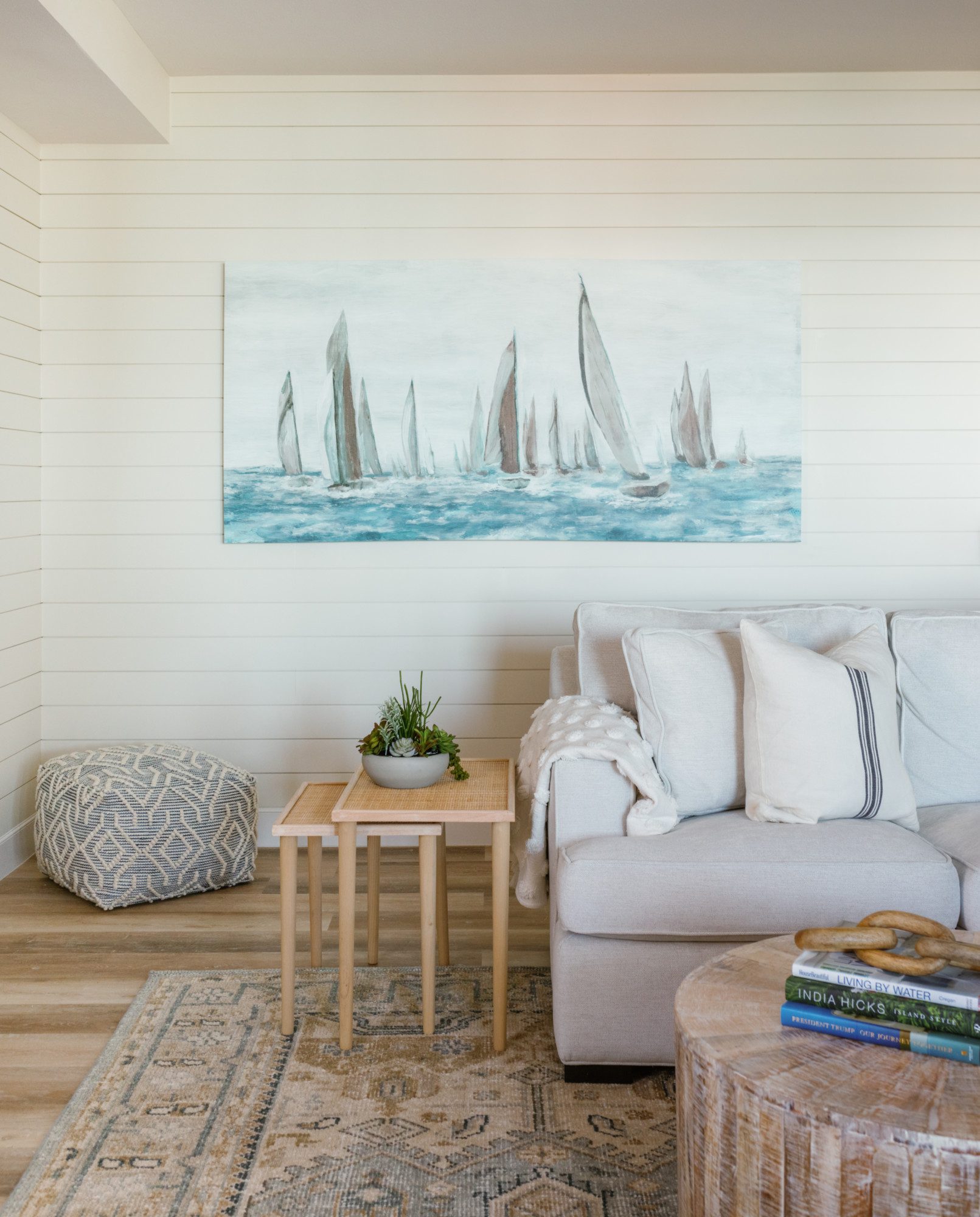 a coastal painting on a wooden accent wall