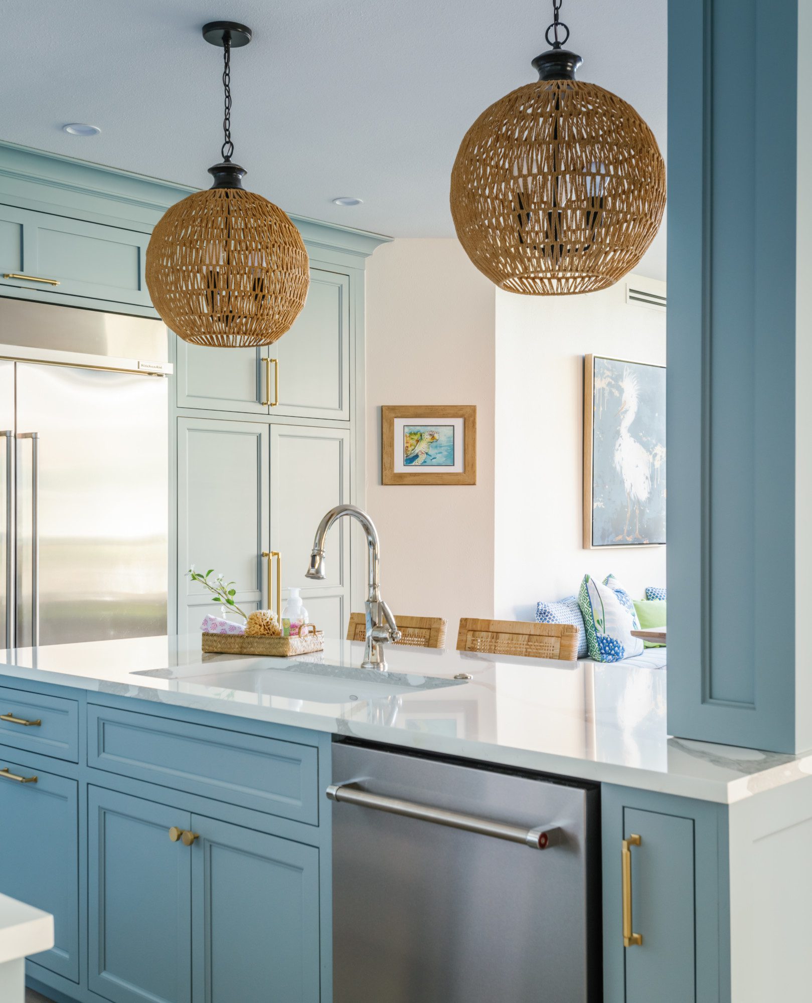 a spacious and bright kitchen with light blue cabinetry