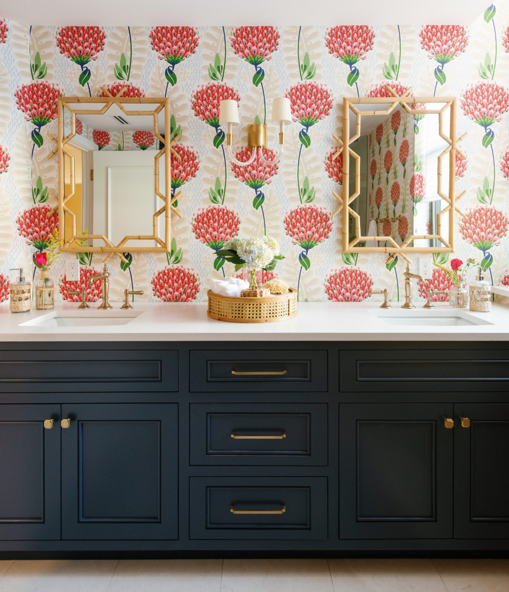 a double vanity with floral wallpaper and natural accents