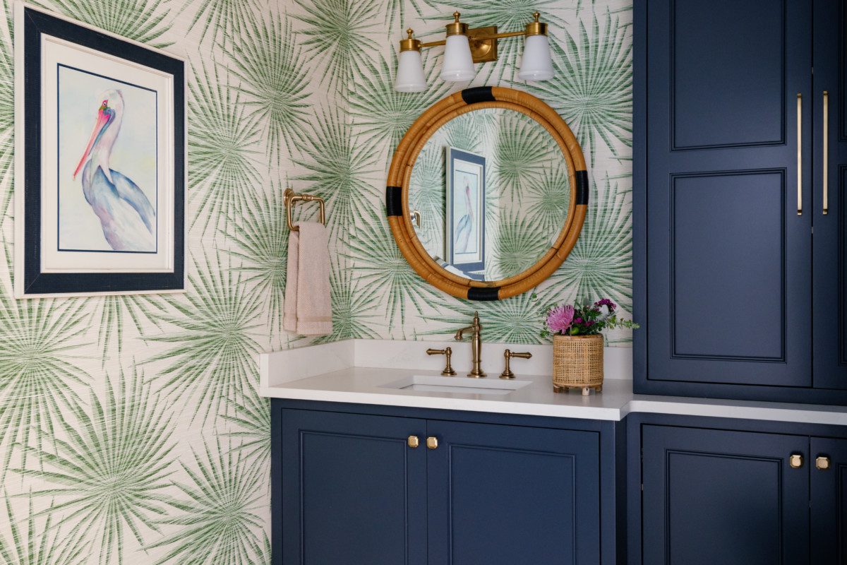 a spacious bathroom with coastal decor and natural accents
