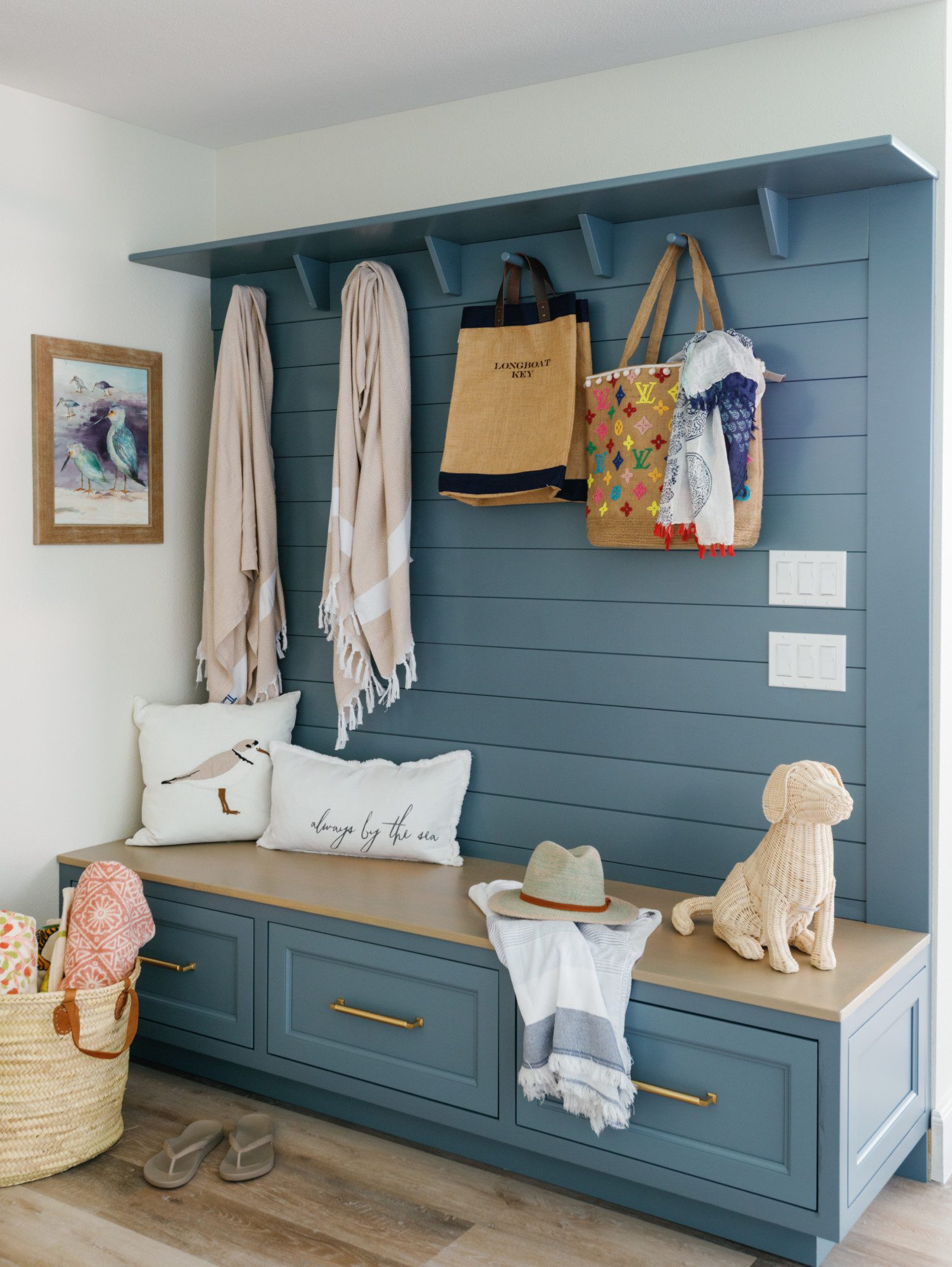 organizational blue cabinetry in a mud room