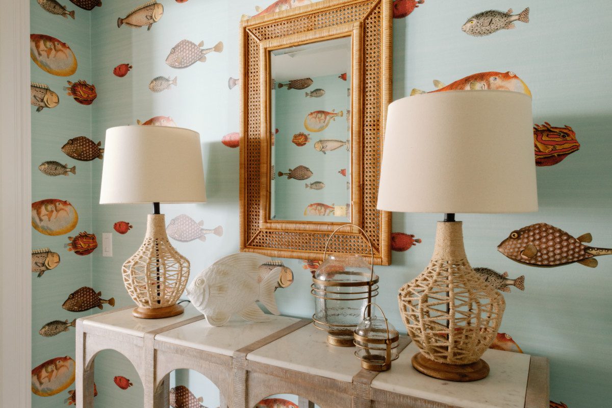 a table with coastal decor against fish wallpaper