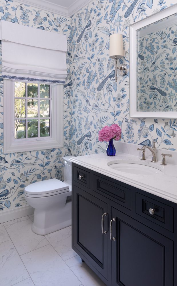 an upscale bathroom with blue floral wallpaper