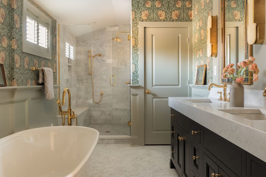 luxurious double vanity with gold accents and dark cabinetry, surrounded with beautiful floral wallpaper