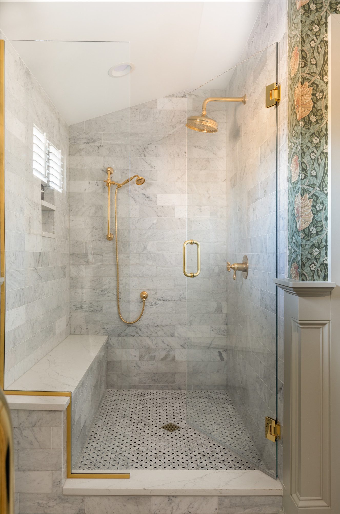 large marble shower with gold fixtures