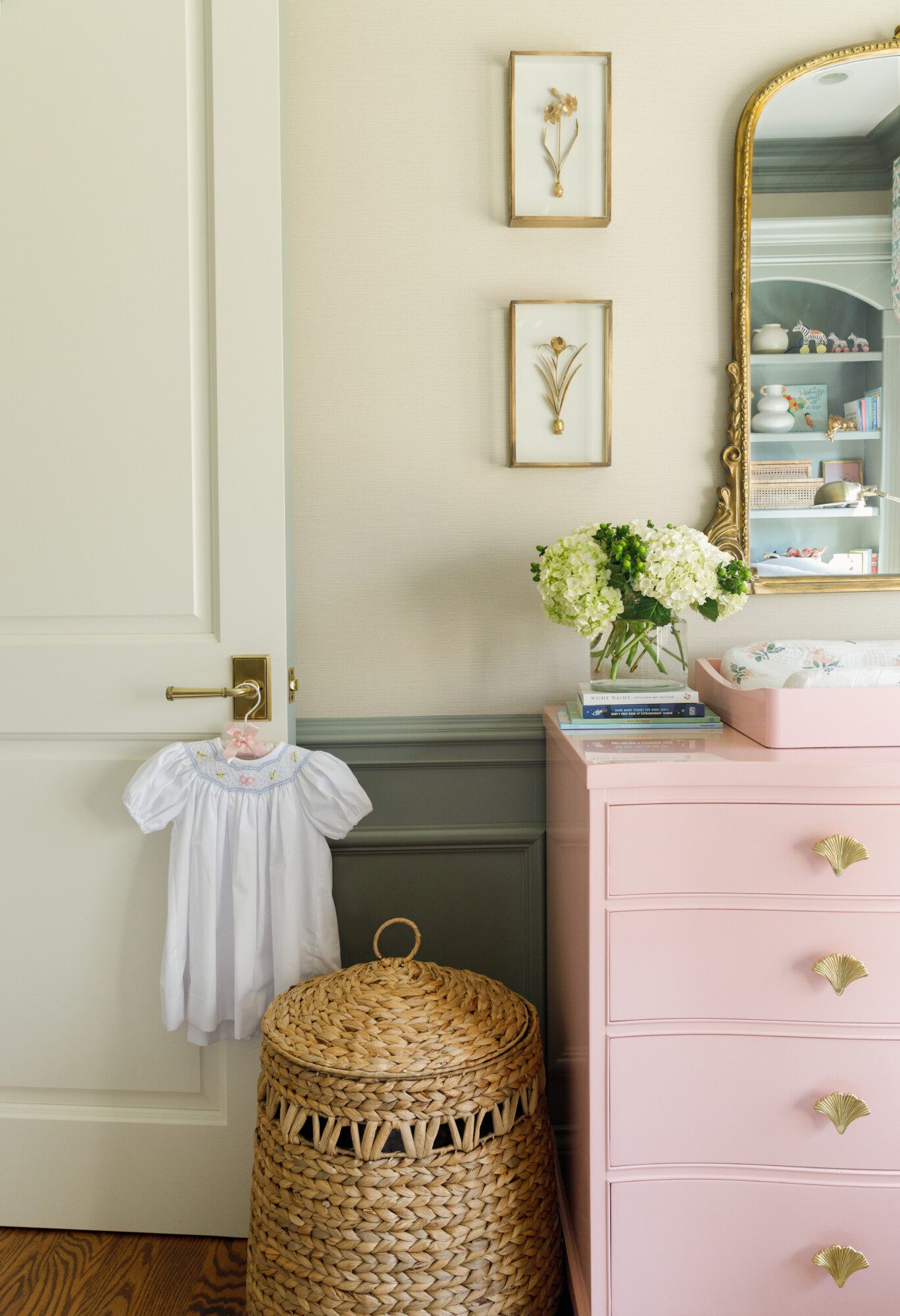 sweet pink dresser and baby dress hanging next to it