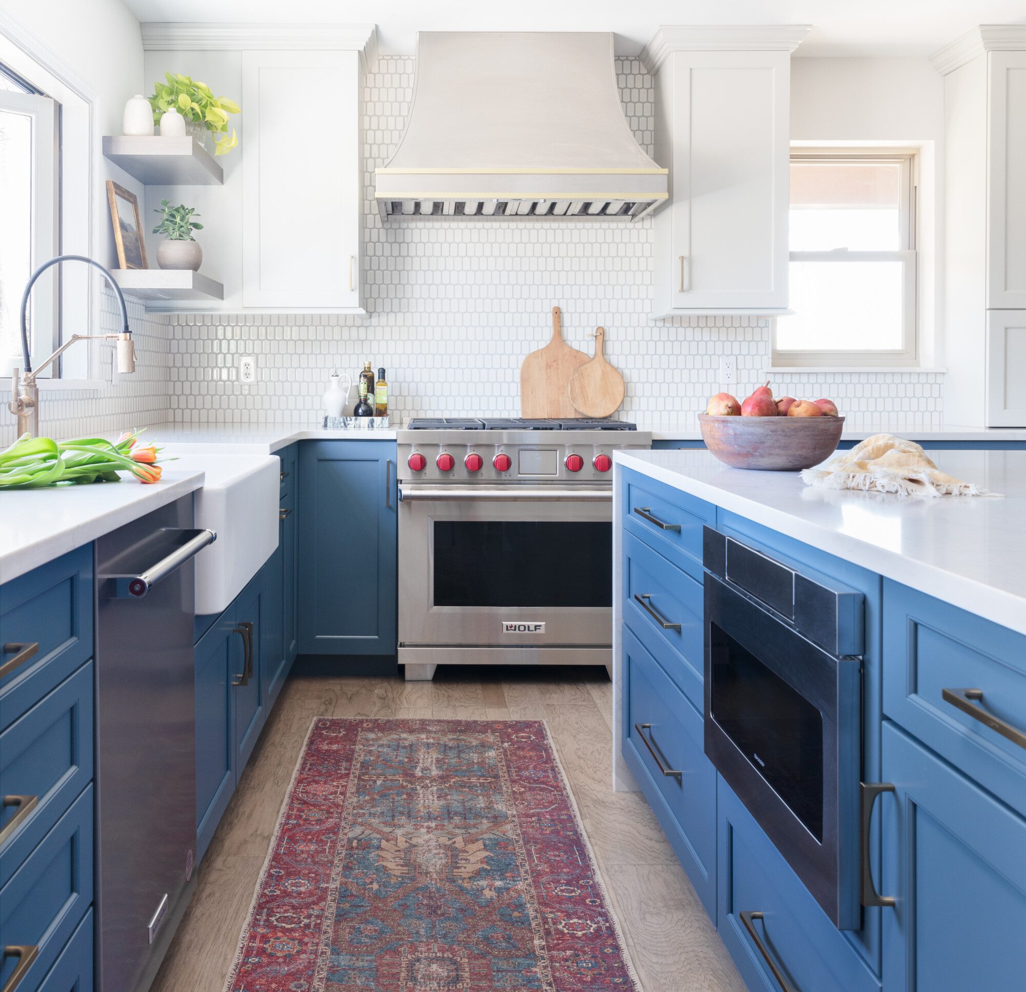 a bright kitchen with blue cabinetry