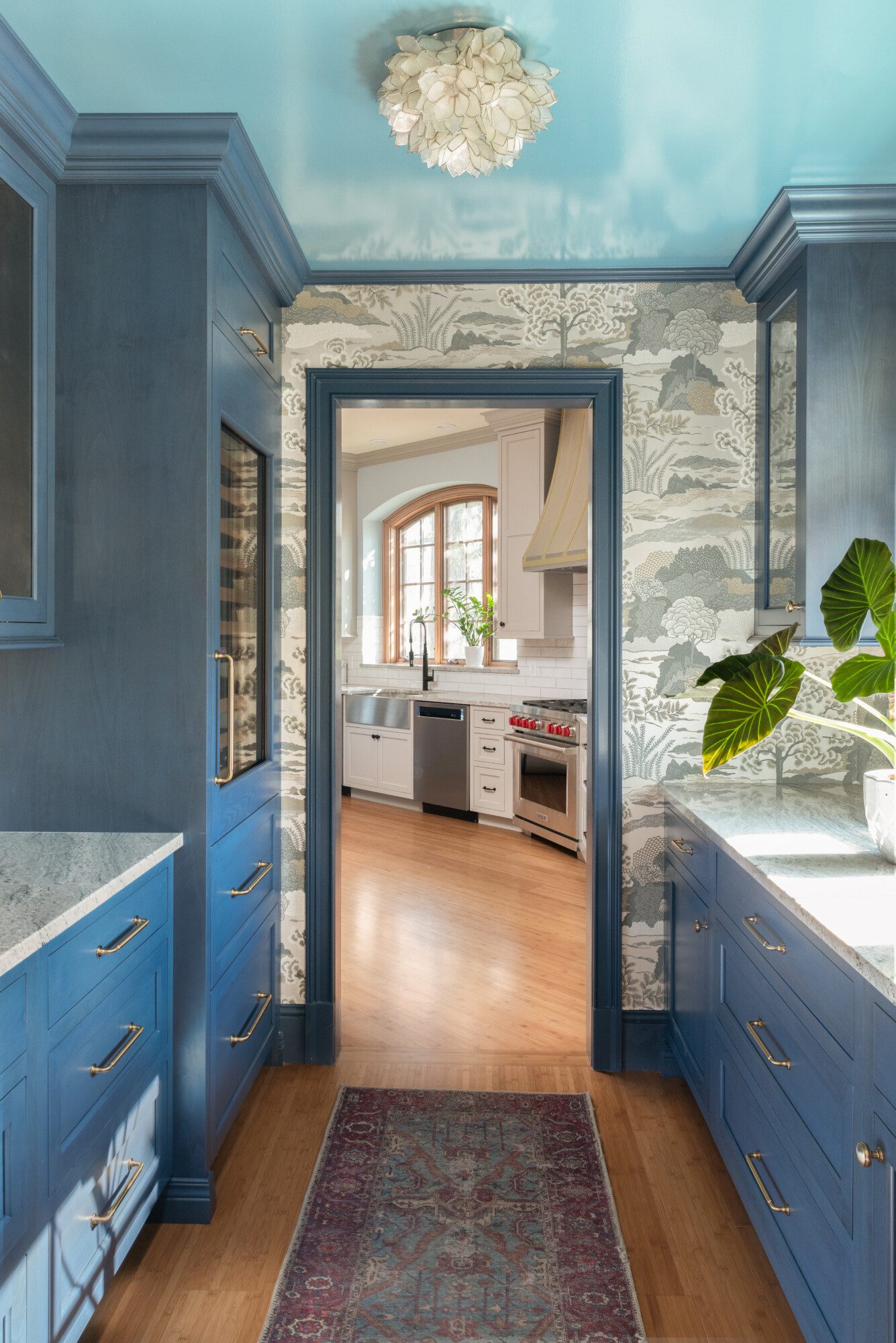 a doorway that leads to the kitchen from the butler pantry