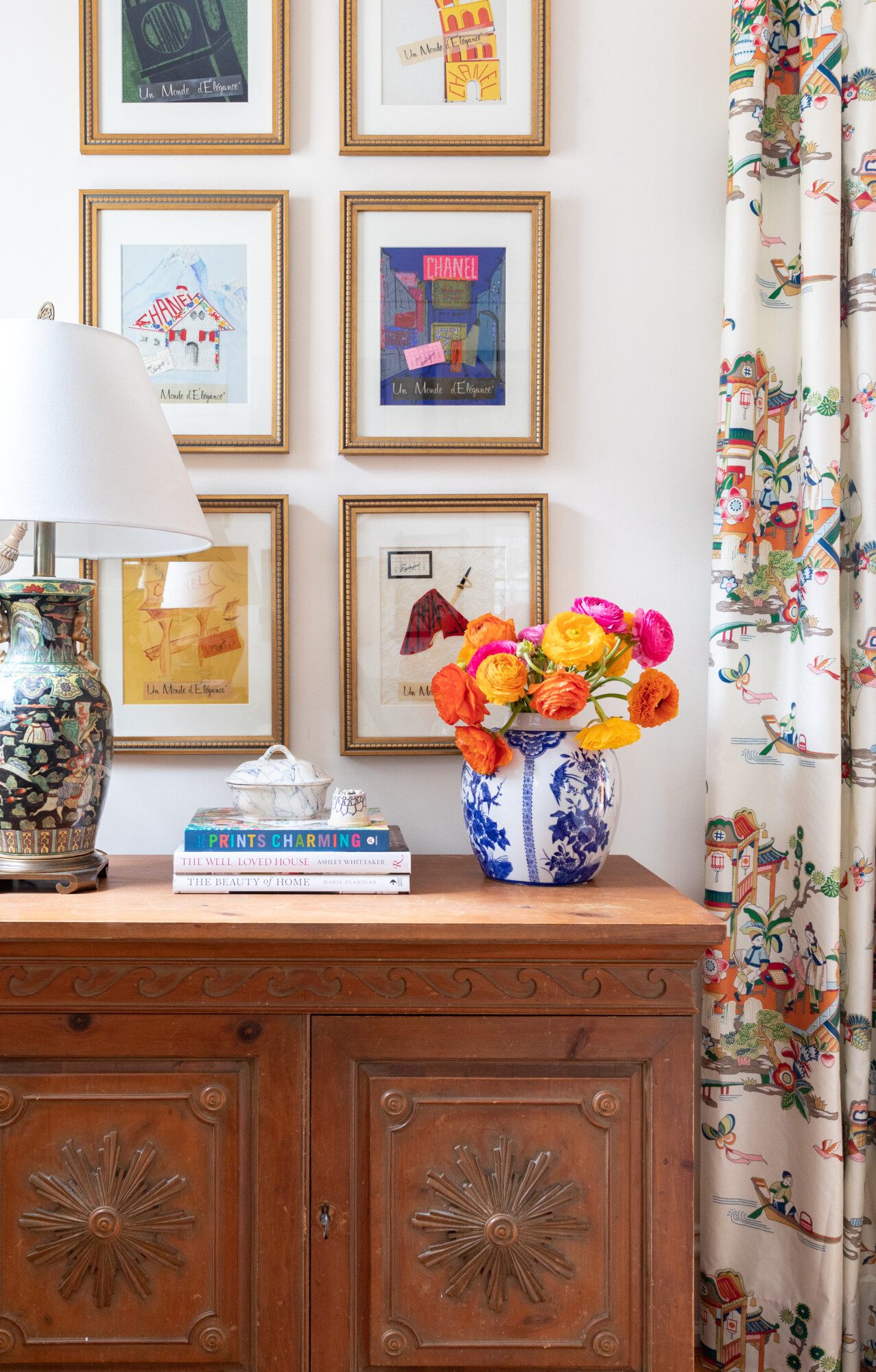 fresh, colorful flowers set on top of a ornate wood credenza