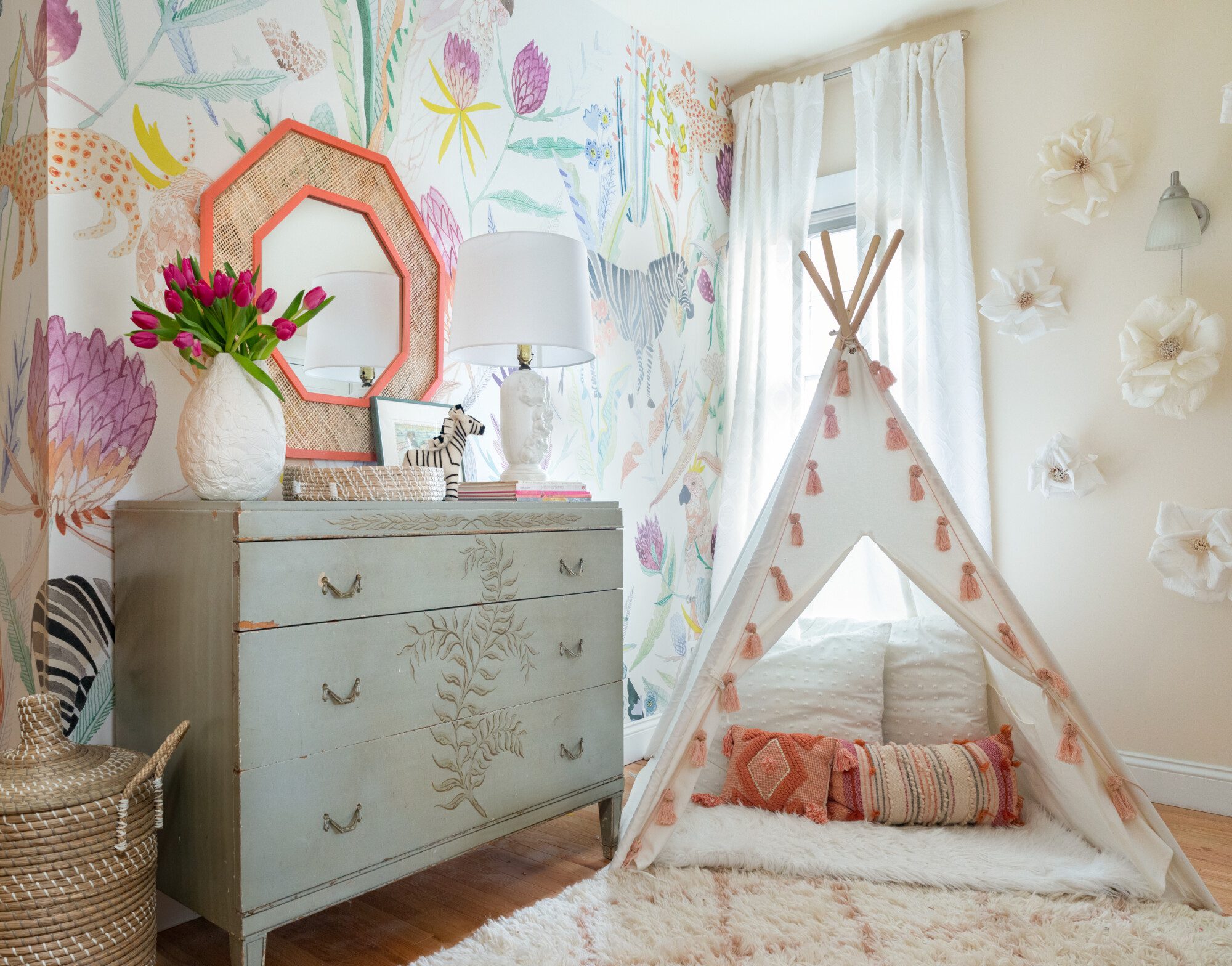 a small tent inside of a colorful nursery is the perfect place for kids to play
