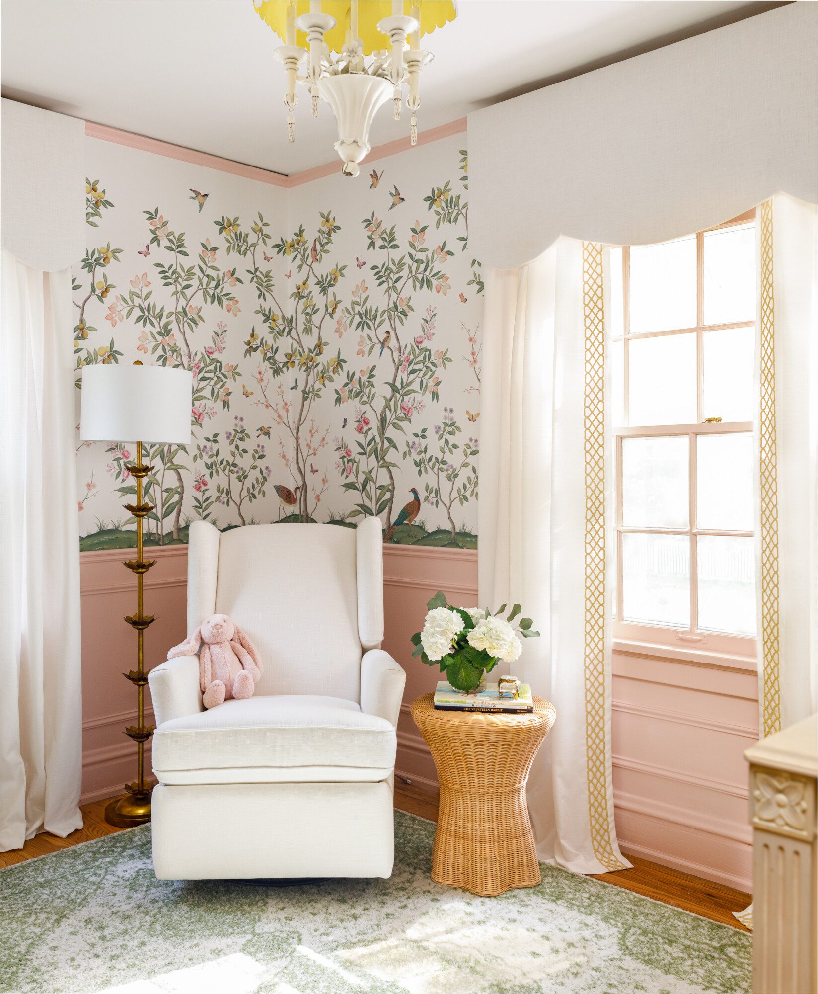 whimsical botanical print wallpaper and a cozy chair in the corner.