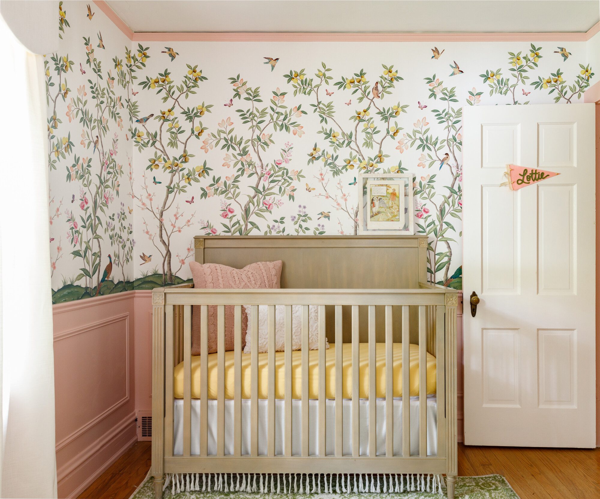 pastel botanical wallpaper is the backdrop of a gorgeous tan crib