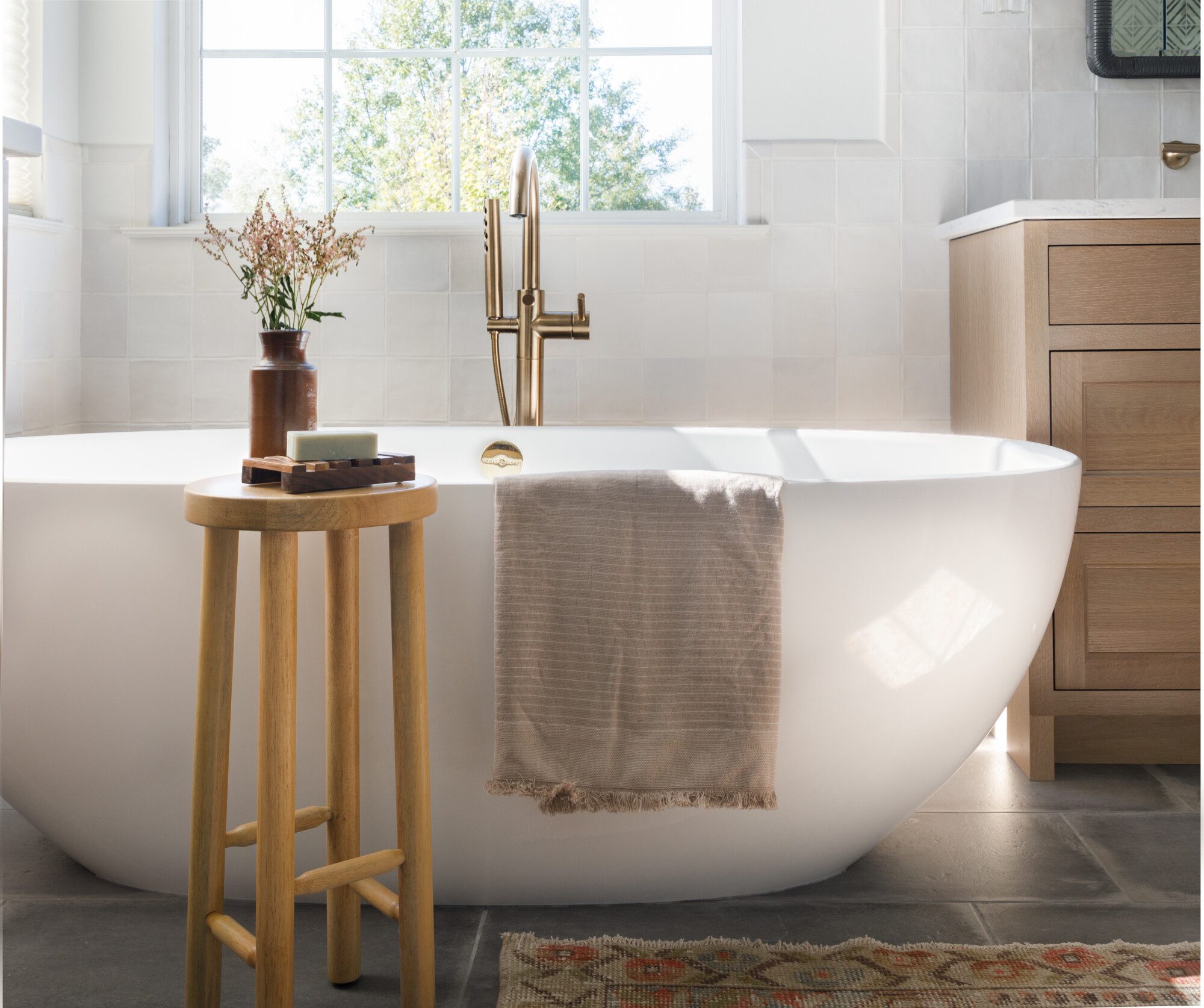 beautiful tub in front of a window with plenty of natural light