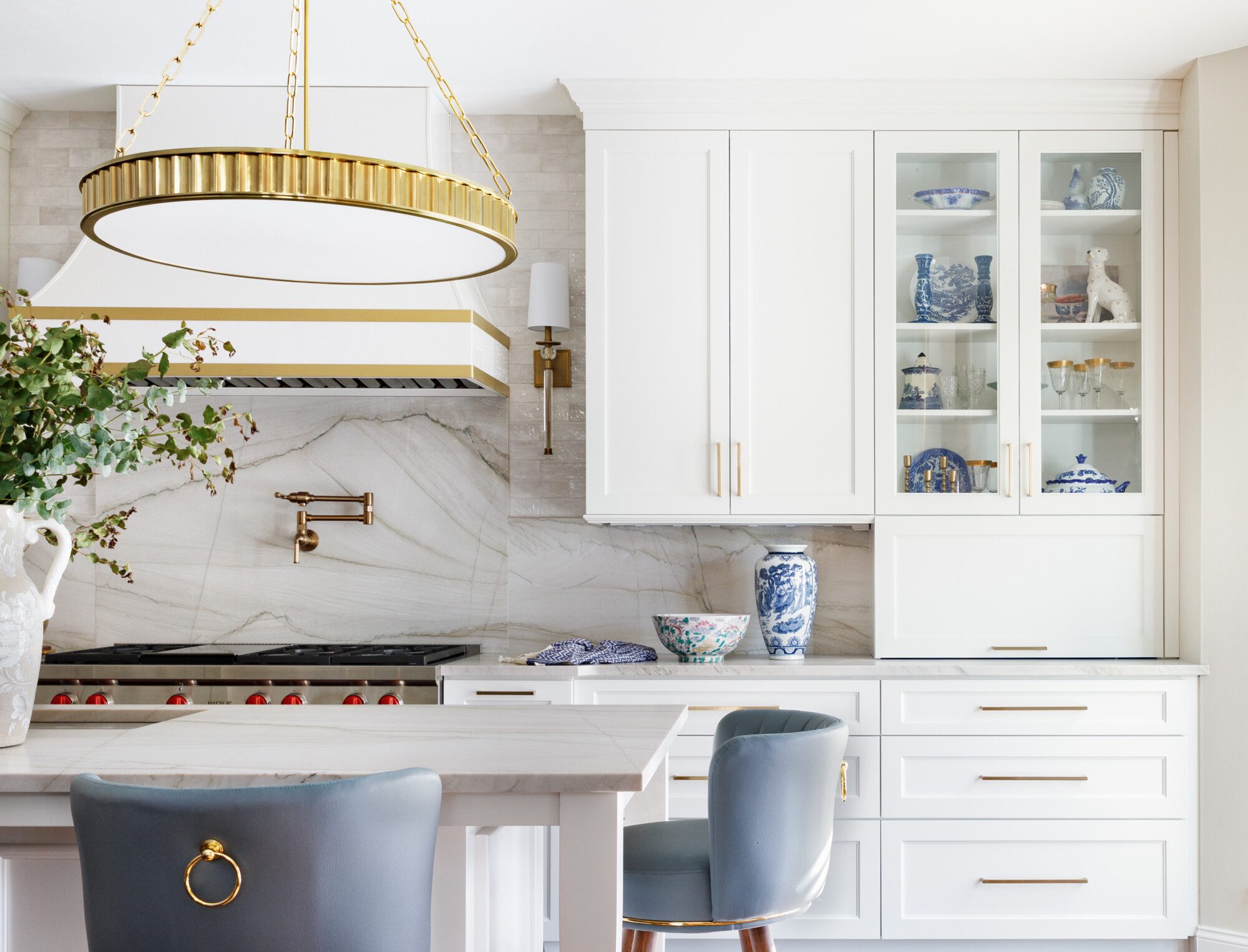 white cabinets and gold accents create a glam kitchen
