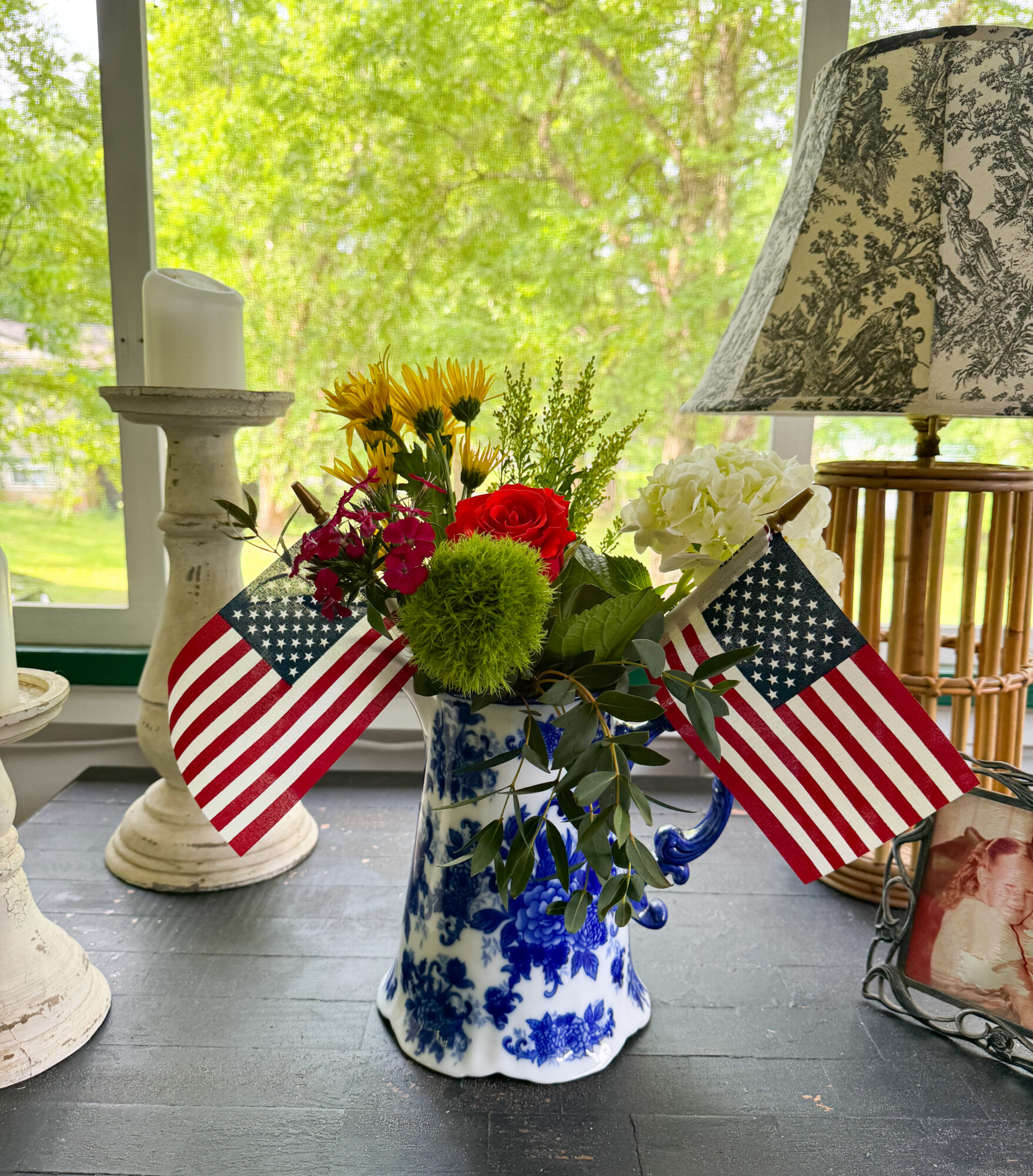 red white and blue floral centerpiece with flags