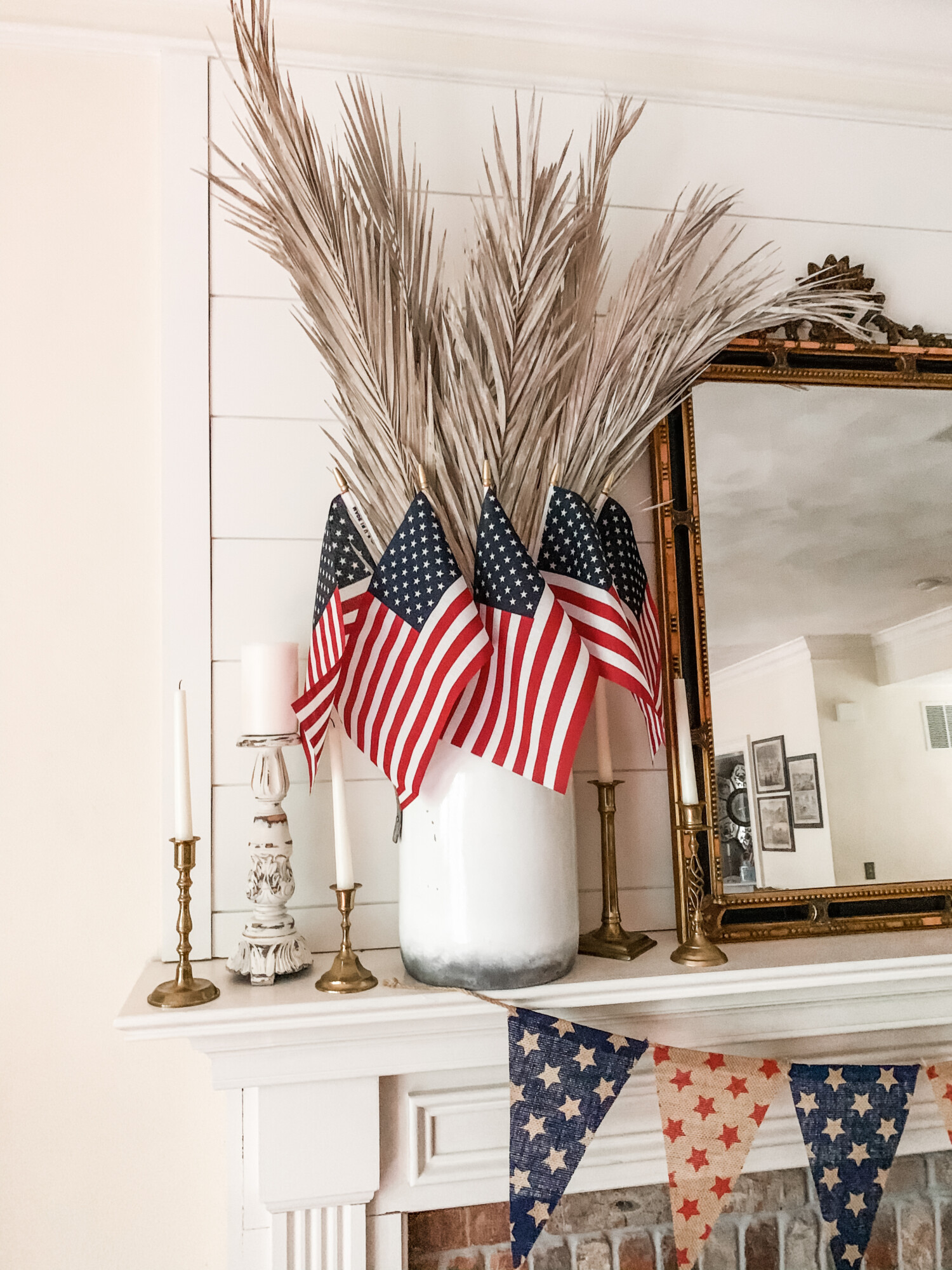 American flags and pampas grass inside of a vase.