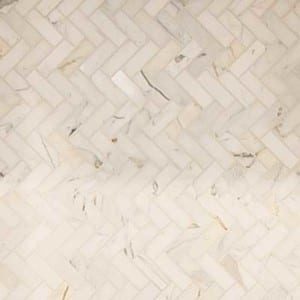 close up of cream colored herringbone tile