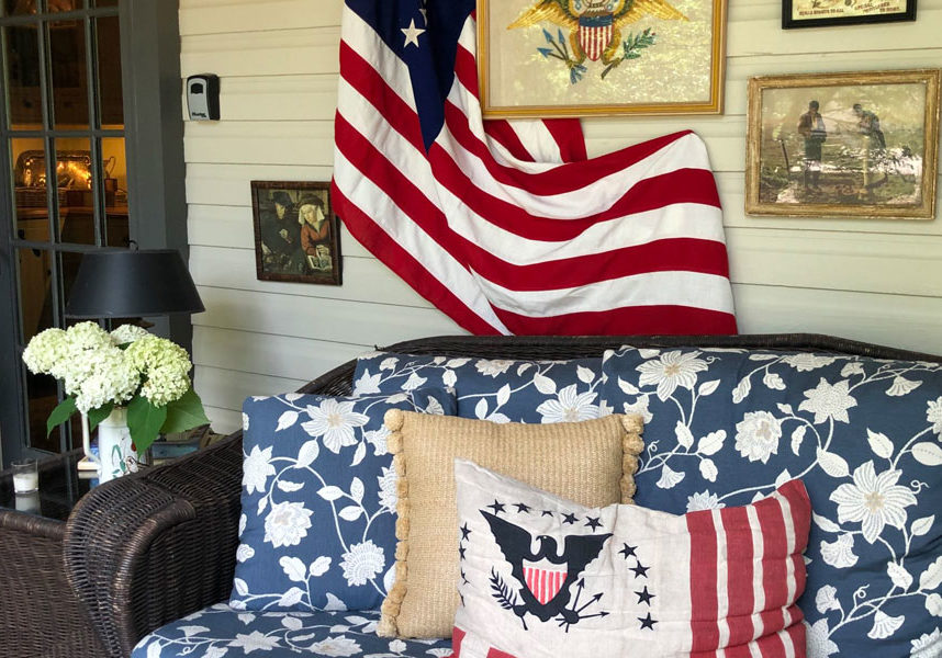 cozy couch on front porch with patriotic decor