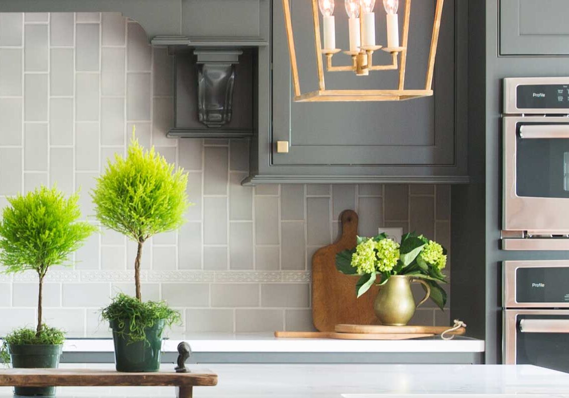Habral-Charoltte-152-Edit-featured close up in an elegant kitchen with charcoal colored cabinets and light aluminum tile backsplash