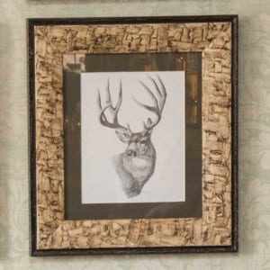 close up of a rustic frame with a sketched deer inside