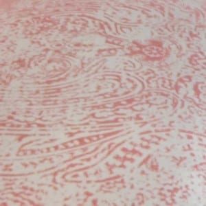 close up of pink and white antique finished tile