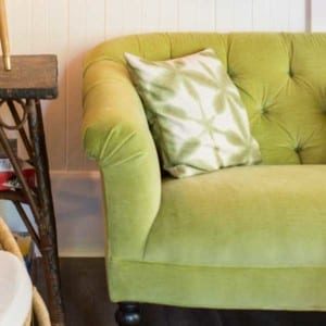 green sofa with green and white pillow