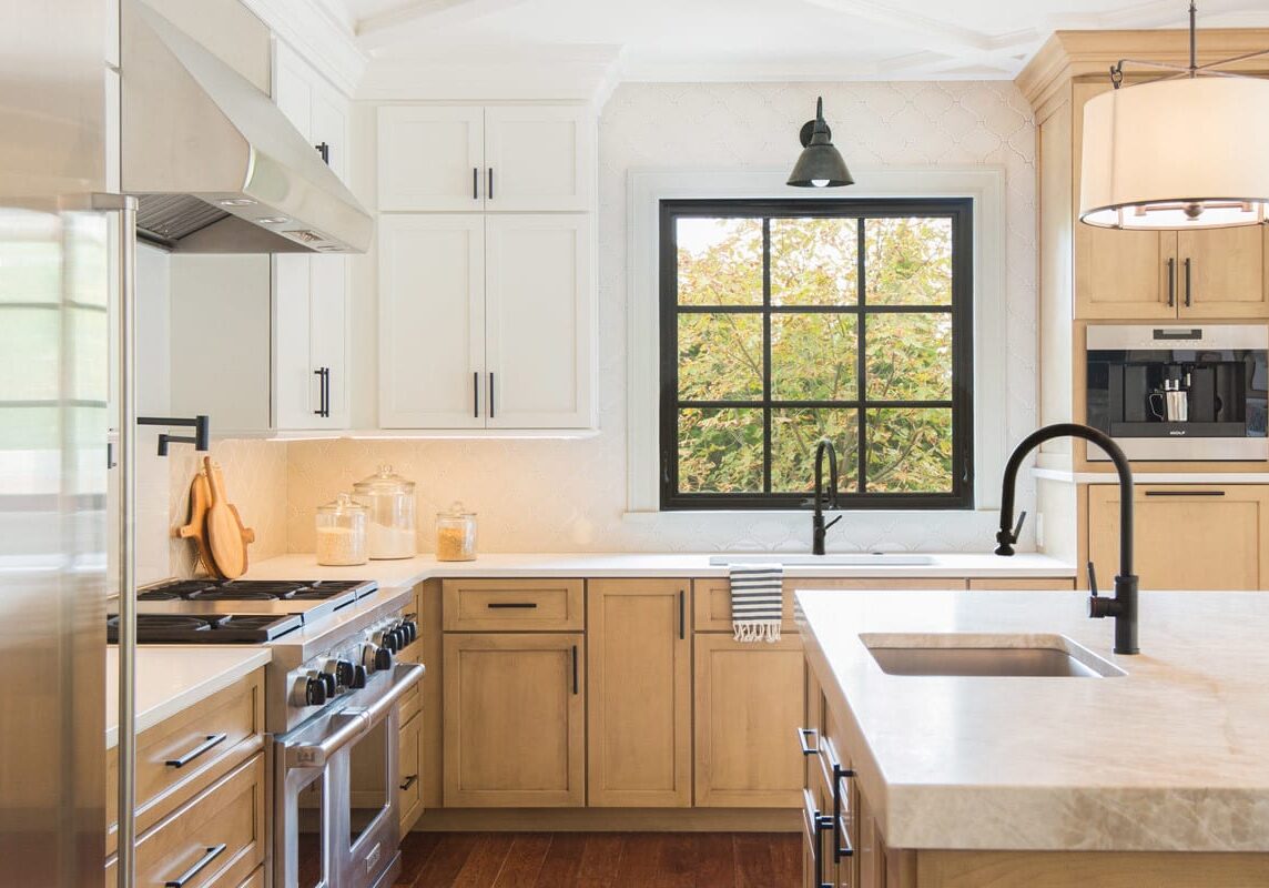 Topping-Estates-Dr-148-Featured Before the remodel, this kitchen was best described as awkward. With a piano shaped island, the space felt inconvenient. Now, everything fits perfectly together. Its neutral hues are warm and inviting The built-in appliances create a seamless flow between other kitchen elements. The matte black hardware pulls in other aspects of the space which helps create depth in contrast.