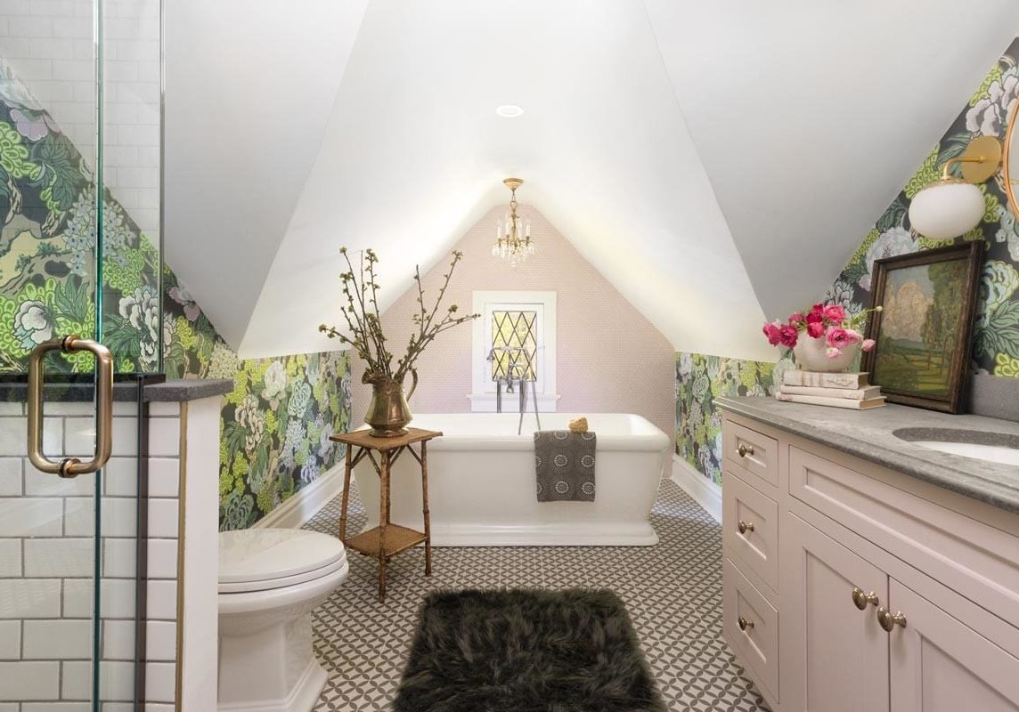 Luxurious bathroom with succulent wallpaper, triangular ceiling and pink cabinets